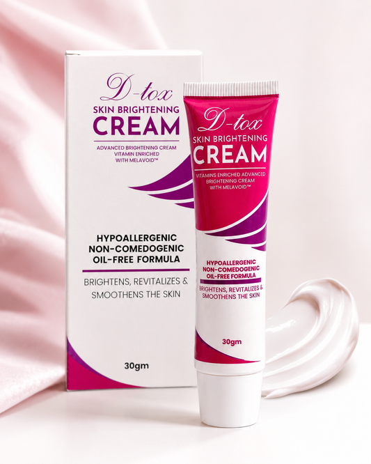 D-tox Skin Brightening Cream shown with its white and magenta packaging box, alongside a dollop of the cream on a soft pink satin background. D-tox Skin Brightening Cream price is 1105 on sale.